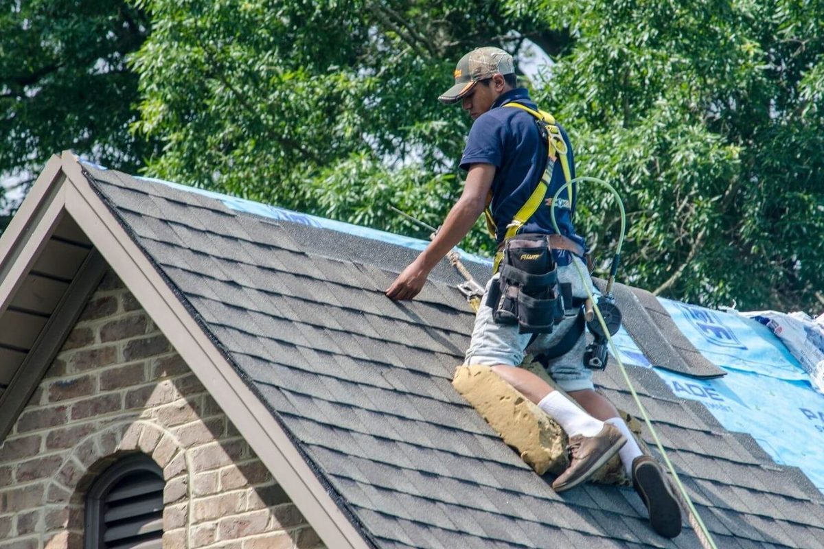 John Beal Roofing roofer working on a residential roof replacement