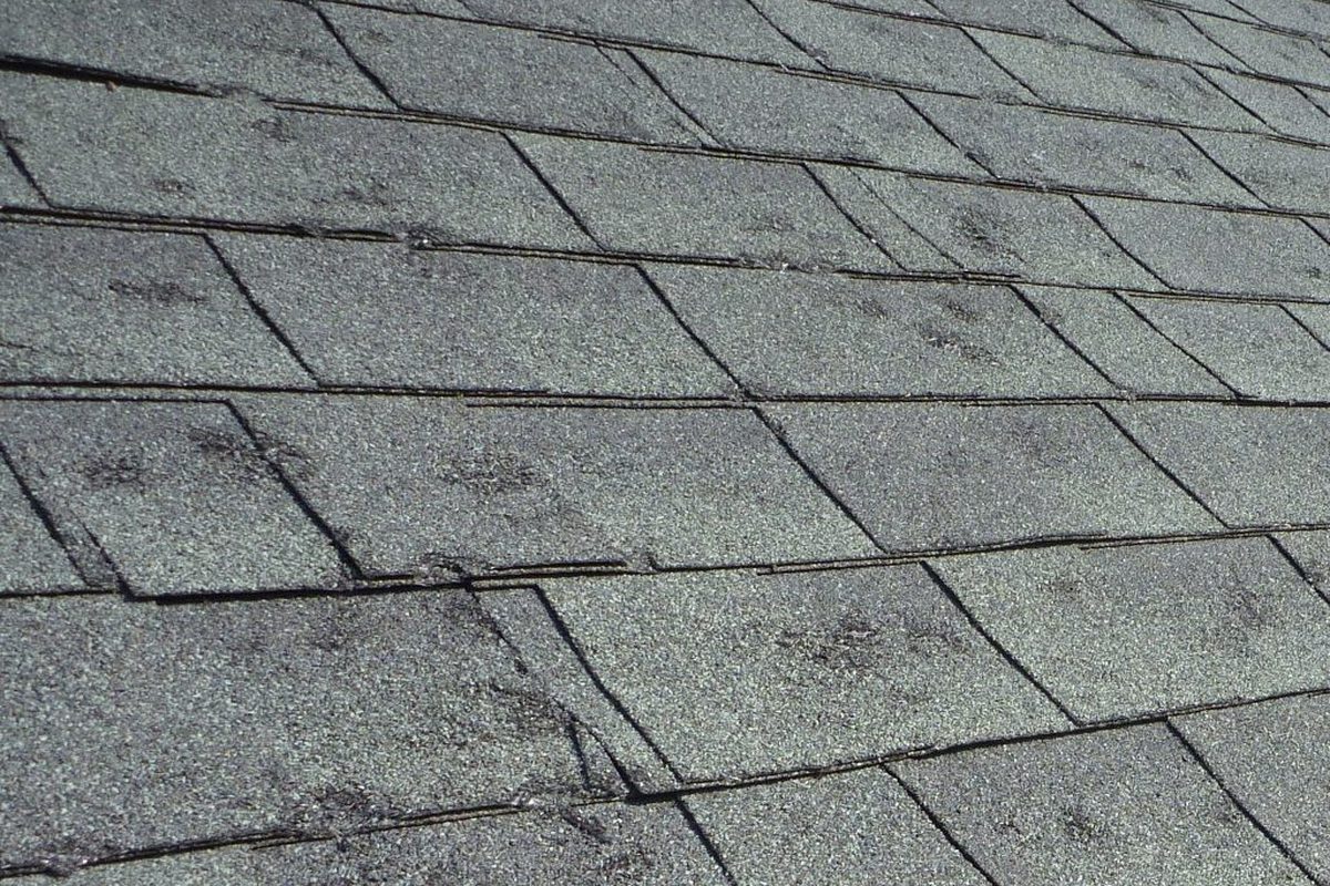 Hail damaged shingles on a Kansas City roof being inspected and marked after a storm