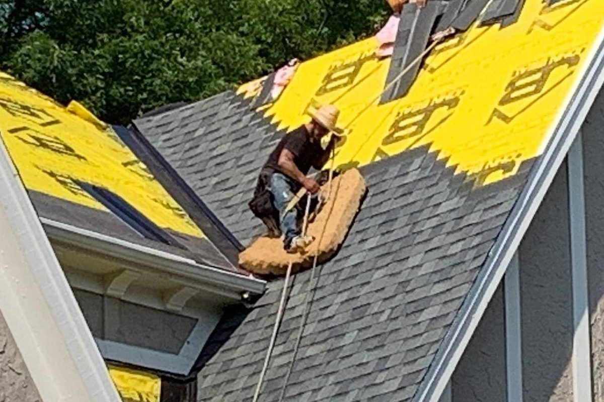 Kansas City roofing company crew installing shingles on a residential roof